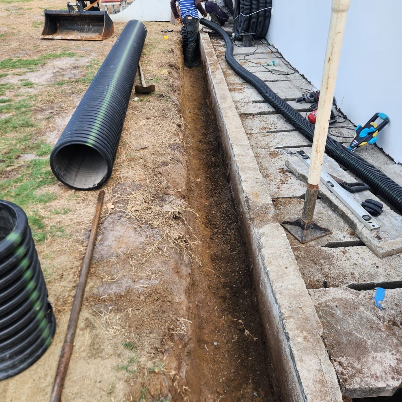 Excavation for subsurface drainage system at Darren Sammy Cricket Grounds in Saint Lucia by Turf Pro Landscaping.